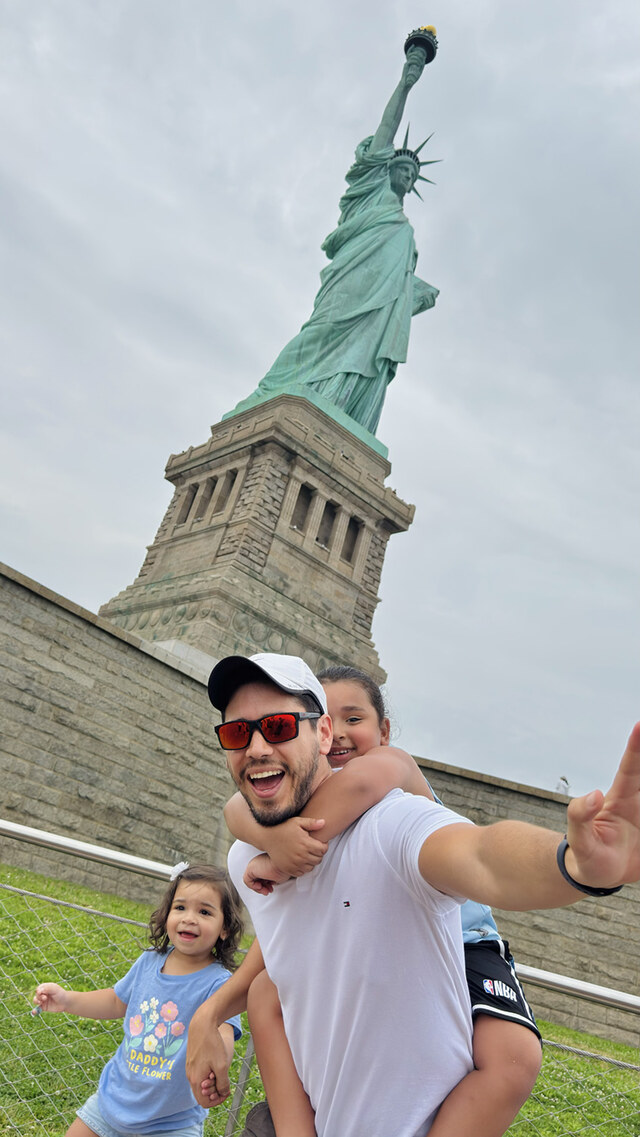 Richard Cichero with his nephews in front of the Statue of Liberty in New York